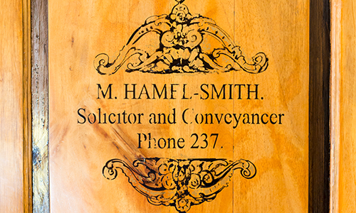 replica of the original letterhead of the founder of the company, 'Mikey' Hamel-Smith, as seen on the door to Mikey's Corner (a reproduction of his office at the Firm which houses his original desk).